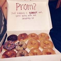 a box filled with lots of donuts sitting on top of a person's lap