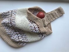 a knitted sweater with an apple in it