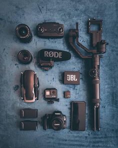 various cameras and accessories laid out on a blue surface with the word rode above them