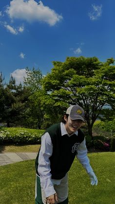 a man standing on top of a lush green field