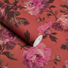 an orange and pink flowered wallpaper with white button on it's end