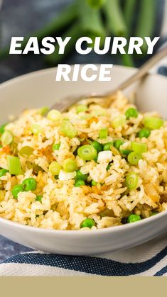 a bowl filled with rice and peas on top of a blue table cloth next to a fork