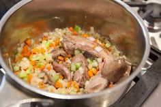 a pot filled with food sitting on top of a stove