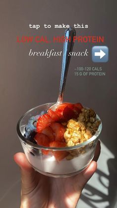 someone is holding up a bowl of cereal and strawberries with the text tap to make this how cal high protein breakfast snack