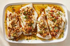 fish with almonds and seasoning in a white dish