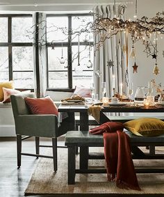 a dining room table and chairs with candles on it