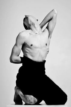 black and white photograph of a man doing yoga