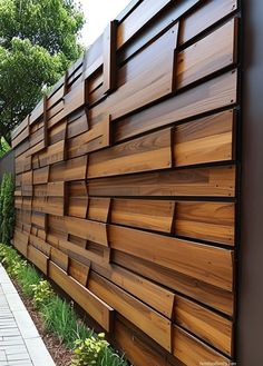 the side of a building with wood panels on it's sides and trees in the background