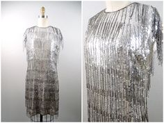 This is a gorgeous vintage hand beaded dress! It's fully embellished with tiered fringe beading and sequins and is in excellent condition! Bust - 35" Waist - 32" Hips - 38" Length - 35"  This dress comes from a pet-free and smoke-free home. If you would like more info or have any questions, please don't hesitate to ask! Gatsby Dress, Dress Silver, Beaded Fringe, Silver Dress, Silver Sequin, Beaded Dress, Hand Beading, Dress Clothes For Women, Gatsby