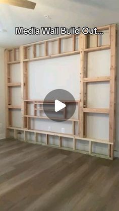 an empty room with wooden shelves and white walls