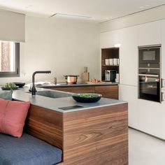 a modern kitchen with an island and sink