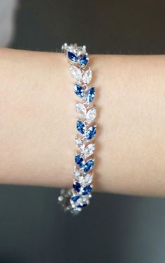 Beauty of our stunning bracelet, a blend of elegance and charm. Crafted with exquisite detail and adorned with sparkling gems, this piece radiates sophistication. Perfect for adding a touch of glamour to any outfit.  #BeautifulBracelet #ElegantDesign #SparklingGems #SophisticatedStyle #GlamorousAccessory #JewelryEssential #StatementPiece Blue Rose Accessories, Simple Elegant Jewelry Silver, Beautiful Bracelet Gold, Blue And Silver Jewelry, Royal Blue Bracelet, New Jewellery Designs, Fancy Items, Fancy Bracelets, Gifts For Mums