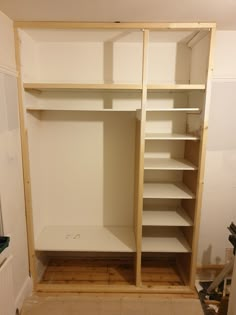 an empty closet with shelves and drawers in it