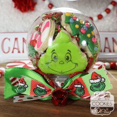 a christmas ornament with candy in the shape of a grin face on it