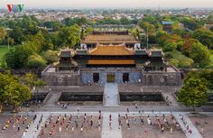 an aerial view of people walking around in front of the forbidden city wall and gate