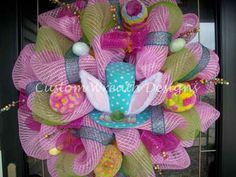 a pink and green mesh wreath with flip flops on it's front door