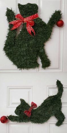 two christmas decorations made out of fake grass and red bows on the front door to look like a cat