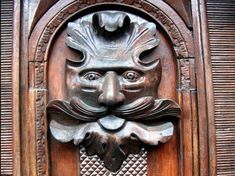 a wooden door with a carved face on it