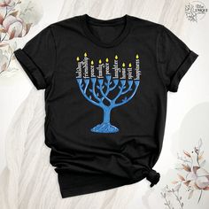 Embrace the festive spirit with our 'Happy Hanukah Candelabra Shirt.' Celebrate the rich traditions and warmth of Hanukkah with this elegantly crafted Jewish Shirt. This Holiday Hanukkah Shirt captures the essence of the season, making it a perfect Hanukkah Gift Shirt. Imbued with Jewish Sayings, it exudes reverence and joy, making it an essential part of your holiday wardrobe. Add a touch of religious significance to your celebrations with this specially designed Holiday Shirt. Happy Hanukah Candelabra Shirt, Jewish Shirt, Holiday Hanukkah Shirt, Hanukkah Gift Shirt,Jewish Saying Shirt, Holiday Shirt,Religious Shirt for Jewish Hello, Welcome to Blue Unique Boutique, your destination for unique and handcrafted shirts! I'm Eve! I have been thinking about creating my business for a long time Hannukah Tshirts, Jewish Sayings, Jewish Christmas, Hanukkah Shirts, Hanukkah Candles, Hanukkah Gifts, Jewish Gifts, Happy Hanukkah, Holiday Shirt