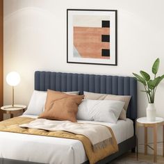 a bed with white sheets and brown pillows in a bedroom next to a painting on the wall