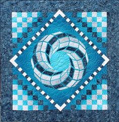 a blue and white quilt with a circular design