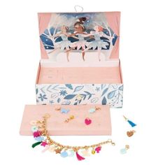 an open box with various items in it on a white background, including necklaces and earrings