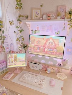 a desk with two computer monitors and a keyboard on it, in front of a pink house