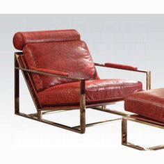 a red leather chair and footstool sitting next to each other