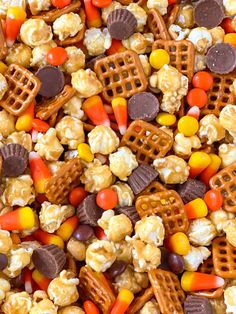 a mixture of candy corn, popcorn and waffles on a sheet of paper