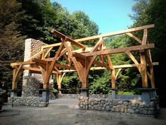 a wooden structure sitting in the middle of a forest