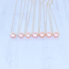 "Price is for one beautiful peachy pink Edison floating pearl necklace. Photos may feature multiple necklaces that can be purchased separately. If you are looking for Bridal Party or Bridesmaids sets, please contact me for pricing information. This chain is made from your choice of either gold filled or sterling silver and will not tarnish and can even get wet! We HIGHLY recommend selecting double rope chain (more durable) for longer necklaces 22\"-26\". Pearls are approximately 10-11mm round/ne Multiple Necklaces, Floating Pearl Necklace, Edison Pearls, Hawaiian Jewelry, Saltwater Pearls, Bridesmaid Necklace, Tahitian Pearls, Wedding Necklaces, Necklaces Jewelry