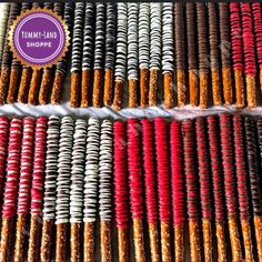 many different colored bracelets on display in front of a purple sign that says mumbai shoppe