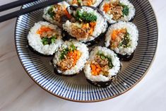 sushi is served on a plate with chopsticks