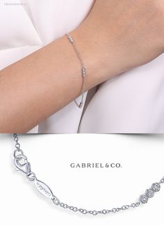 Trios of sparkling diamonds set in crisp hexagonal frames are stationed at three points along this delicate tennis bracelet. The adjustable cable chain is crafted from rich 14k white gold for a timeless elegance. In all this bracelet flaunts 0.08cts of radiant diamonds.  TB4208W45JJ #GabrielNY#DiamondJewelry#FineJewelry#GabrielAndCo#UniqueJewelry#FineJewelry#FashionJewelry#UniqueJewelry#GiftIdeas#UniqueGifts#DiamondJewelry #Jewelry #DiamondBracelet #GoldBracelet#Bracelet#WhiteGoldBracelet White Gold Diamond Tennis Bracelet With Halo Setting, Tarnish-resistant White Gold Diamond Bracelet For Wedding, Elegant Hand-set Diamond White Bracelet, White Diamond-accented Chain Bracelet, White Gold Diamond Bracelets, Tarnish Resistant, Hexagon Bracelet, Stackable Bangles, Hexagon Diamond, Classic Bracelets