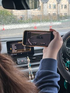 a woman is using her cell phone while driving