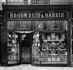 an old black and white photo of a store front