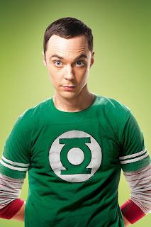 a man wearing a green lantern shirt with his hands on his hips looking at the camera