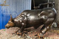 a statue of a bull in front of a building