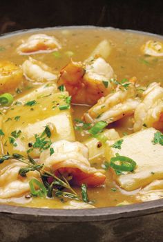 a pot filled with chicken and dumplings on top of a table