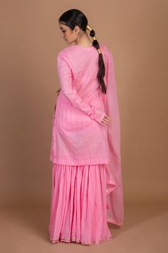 Light deep pink straight cotton straight kurta with gota work. Paired with a gharara and dupatta.
Components: 3
Pattern: Gota Embroidery
Neckline: Scoop Neck
Sleeve Type: Churidar Sleeves
Fabric: Cotton
Color: Pink
Other Details: 
Length:
Kurta: 38 inches
Gharara: 40 inches
Weight: under 1 kg
Note: Potli bag shown in the image is not for sale
Occasion: Puja - Aza Fashions Pink Cotton Sharara With Dupatta, Unstitched Cotton Sharara For Wedding, Cotton Palazzo Set For Wedding, Designer Pink Cotton Traditional Wear, Pink Cotton Dress With Dupatta, Pink Cotton Traditional Wedding Wear, Pink Cotton Wedding Sets, Pink Cotton Sharara With Straight Kurta, Designer Cotton Pink Anarkali Set