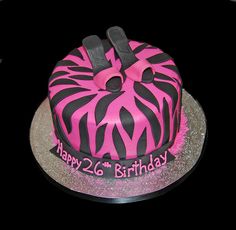 a pink and black zebra print birthday cake with the number twenty six on it's side