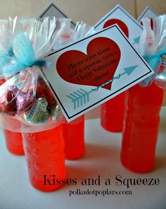 candy in plastic cups with tags on them for valentine's day party favors and free printables