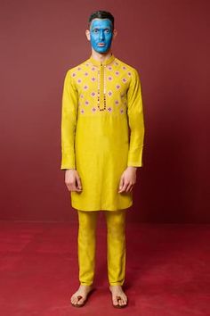 Sunflower mustard kurta with resham hand embroidery. Comes with tonal pant.
Components: 2
Pattern: Hand embroidered
Type Of Work: Resham
Neckline: Mandarin collar
Sleeve Type: Full
Fabric: Viscose raw silk, Pure cotton voile
Color: Yellow
Other Details: 
Length:
Kurta: 40 inches
Pant: 40.5 inches
Closure: Kurta - Front buttons
Occasion: Sangeet - Aza Fashions Festive Mustard Kurta With Resham Embroidery, Cotton Sherwani With Dabka Work For Spring, Traditional Wear With Gota Work For Spring, Traditional Yellow Chanderi Sherwani, Yellow Chanderi Sherwani With Traditional Drape, Yellow Sherwani With Resham Embroidery In Chanderi, Yellow Chanderi Sherwani With Resham Embroidery, Designer Yellow Chanderi Sherwani, Festive Mustard Straight Kurta Set