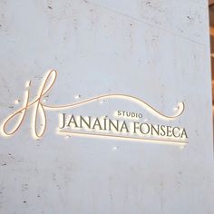 the logo or sign on the side of a building that is white with gold lettering