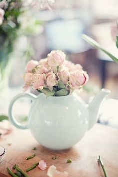 there is a teapot with flowers in it and the words, uma linda tarde para voce?