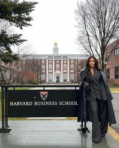 a woman standing in front of harvard business school