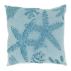 a blue pillow with an embroidered starfish design