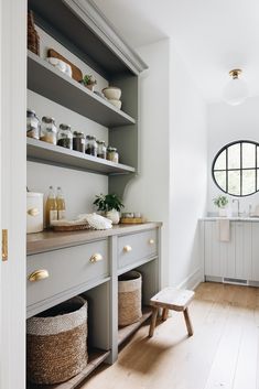 Light gray cabinetry bounces the natural light beautifully in this butler's pantry.