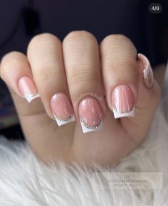 a woman's hand with pink and white french manies on top of her nails