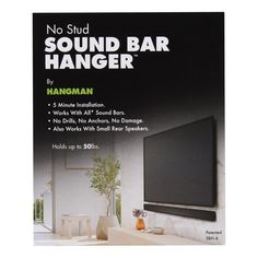 an advertisement for a sound bar hanging on the wall in front of a flat screen tv